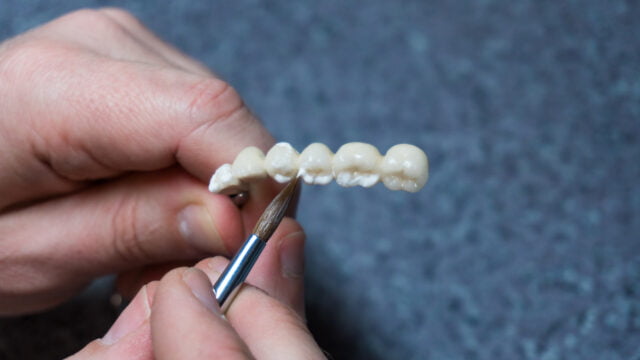dental technician creates dental prostheses laboratory closeup